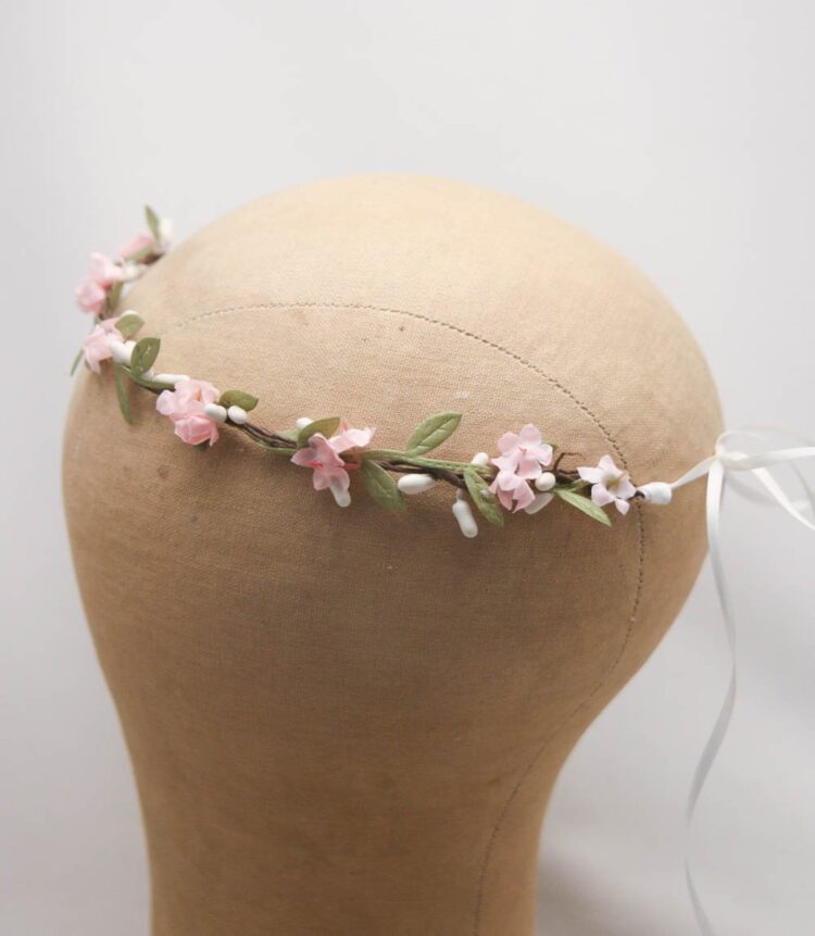 delicate flower crown with pink flowers and green leaves