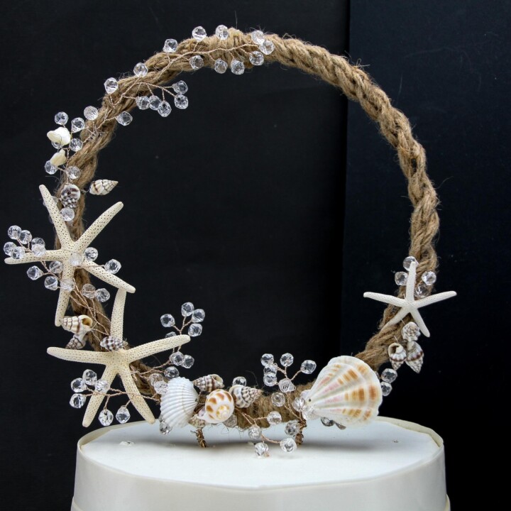 beach wedding cake topper with starfish and sea shells and crystals on a rope circle